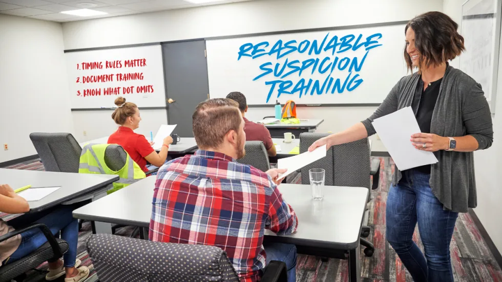 Supervisors attend DOT reasonable suspicion training in a classroom, reviewing documentation, timing rules, and practical best practices for compliance.