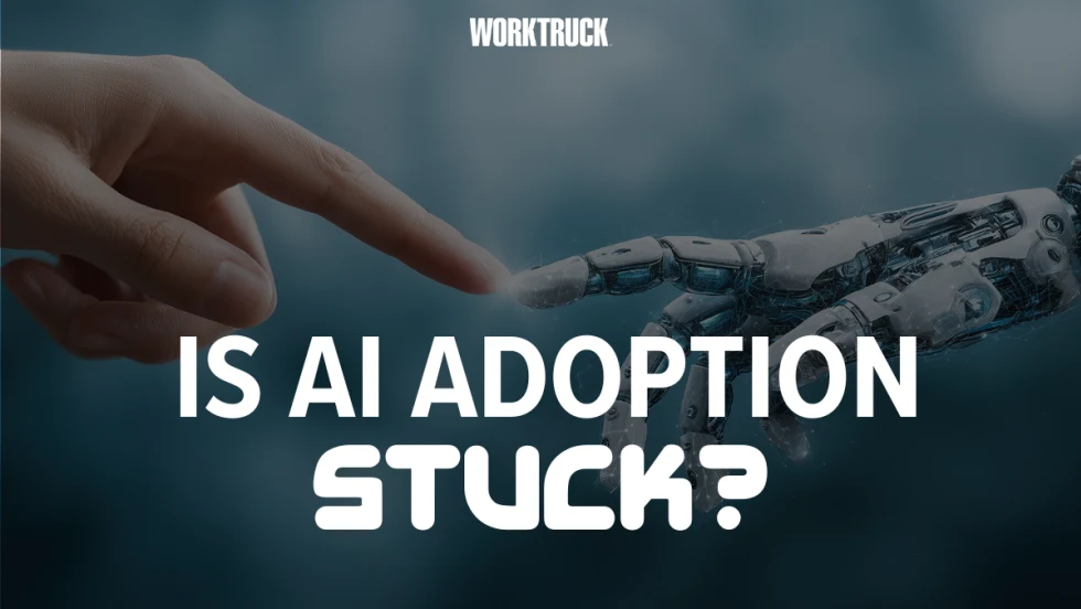 Work Truck graphic reading “Is AI Adoption Stuck?” with a human and robotic hand touching, illustrating fleet AI adoption trends from Fleetio’s 2026 report.