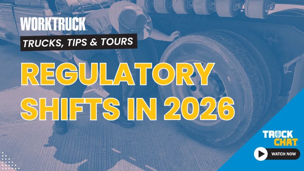 Background image of an officer inspecting a commercial truck's tires with headline Regulatory Shifts in 2026 and logos for Work Truck and Truck Chat. 