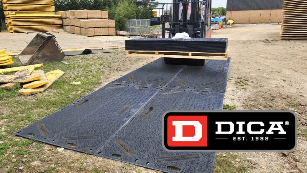 Rubber mat on a construction site with a small tractor driving onto it.