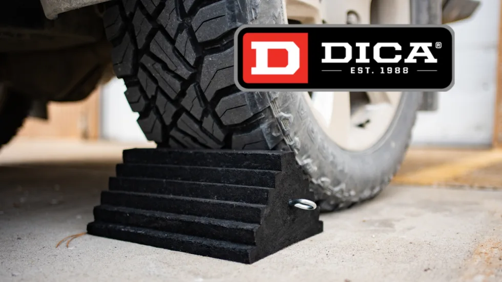 Image of a truck tire parked against a rubber wheel chock and a logo for DICA.