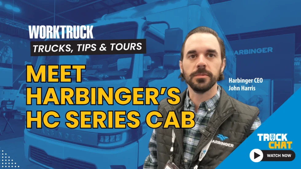 Man standing in front of an image of a blue-tinted box truck with logos for Work Truck and Truck Chat, and a yellow headline, Meet Harbinger's HC Series Cab.