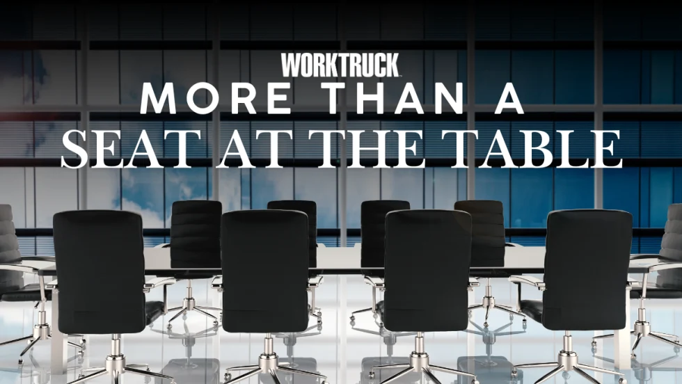 Modern conference room with empty chairs and large windows, overlaid with text “Work Truck More Than a Seat at the Table,” symbolizing industry leadership and collaboration.