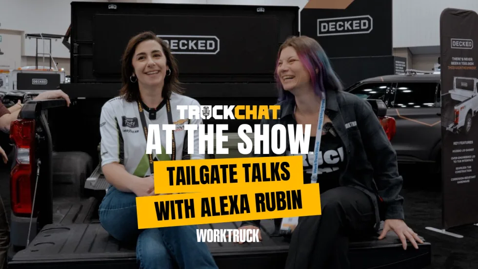 Alex Rubin and Lauren Fletcher smile on a tailgate in the DECKED booth, Truck Chat at the Show Tailgate Talks