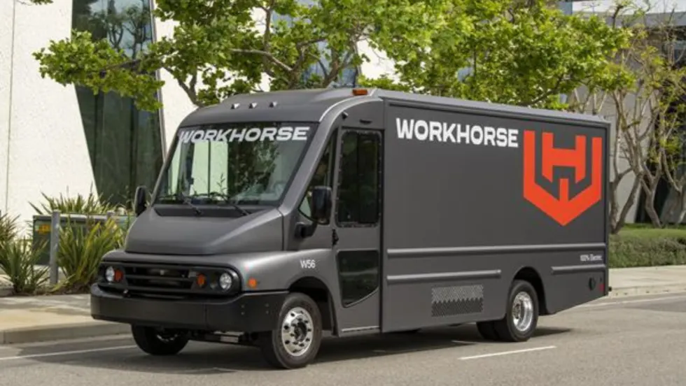 side view of a gray step van with a Workhorse logo parked in a paved parking lot. 