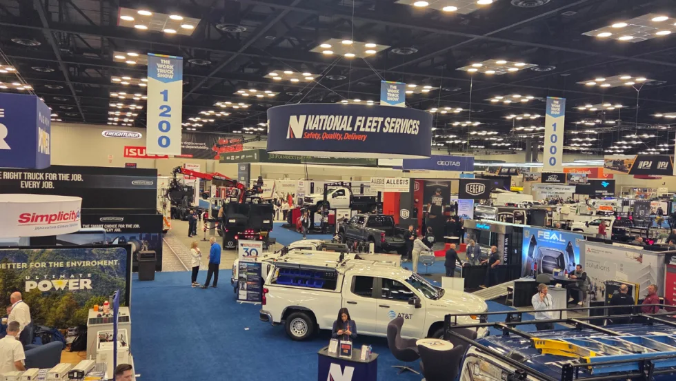 Wide view of Work Truck Week 2026 show floor with trucks, booths, and attendees exploring commercial vehicle equipment and fleet technology exhibits.