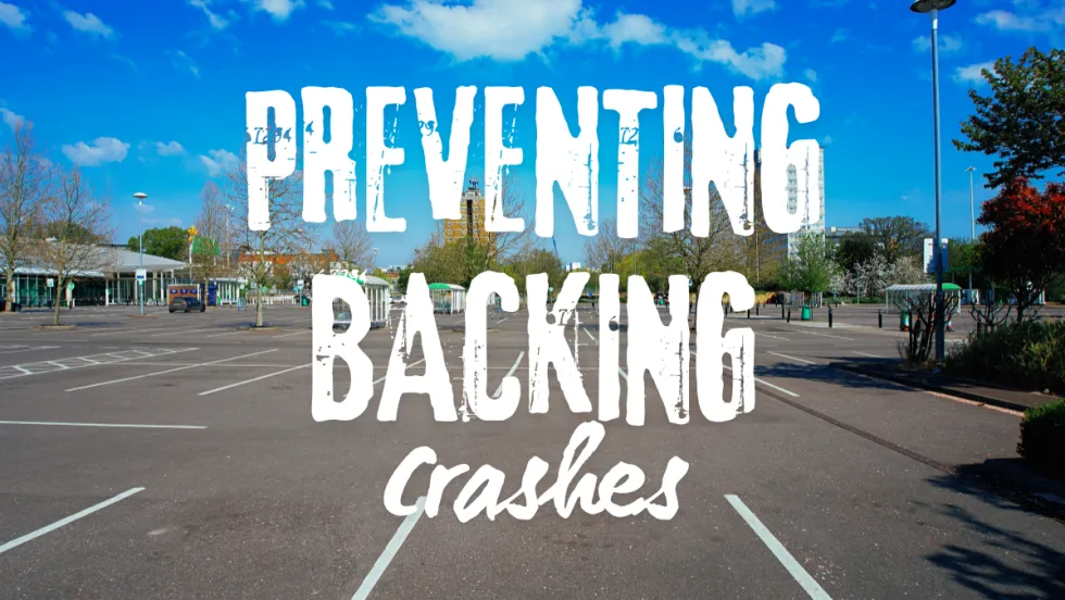 Empty parking lot representing common locations for backing accidents and the need for driver awareness and caution when reversing vehicles.