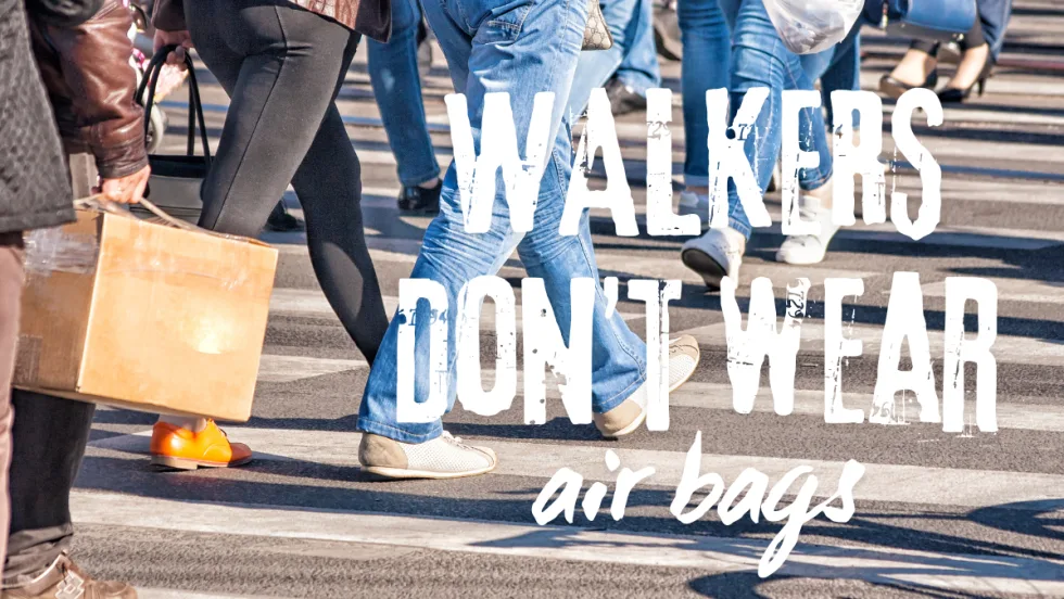 Pedestrians crossing a busy street, highlighting the importance of driver awareness and caution to prevent pedestrian accidents.