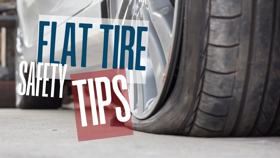 Close-up of a flat car tire on the roadside, illustrating the importance of safe handling and proper response during a tire emergency.