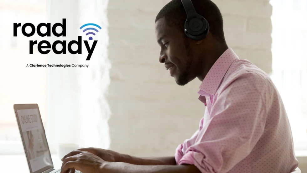 side view of a man working on a laptop computer with upper left logo for Road Ready.