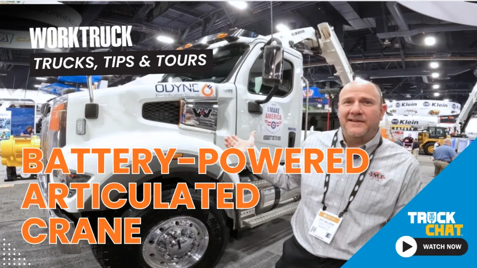 Man talking in front of a large crane truck with headline Battery-Powered Articulated Crane and logos for Truck Chat and Work Truck.