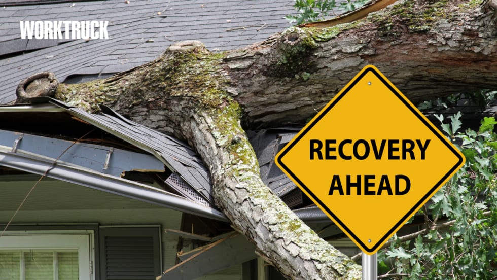 Large fallen tree crushing a house roof with a “Recovery Ahead” sign, symbolizing disaster aftermath and increased operational risks during recovery phases.