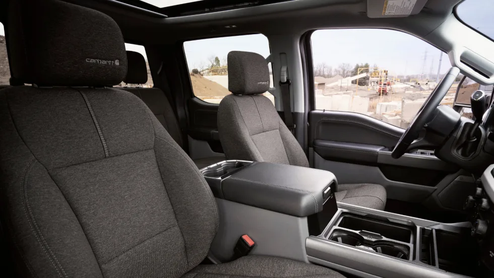 Interior view of Ford Super Duty Carhartt edition showing dark cloth seats with Carhartt logos and center console.