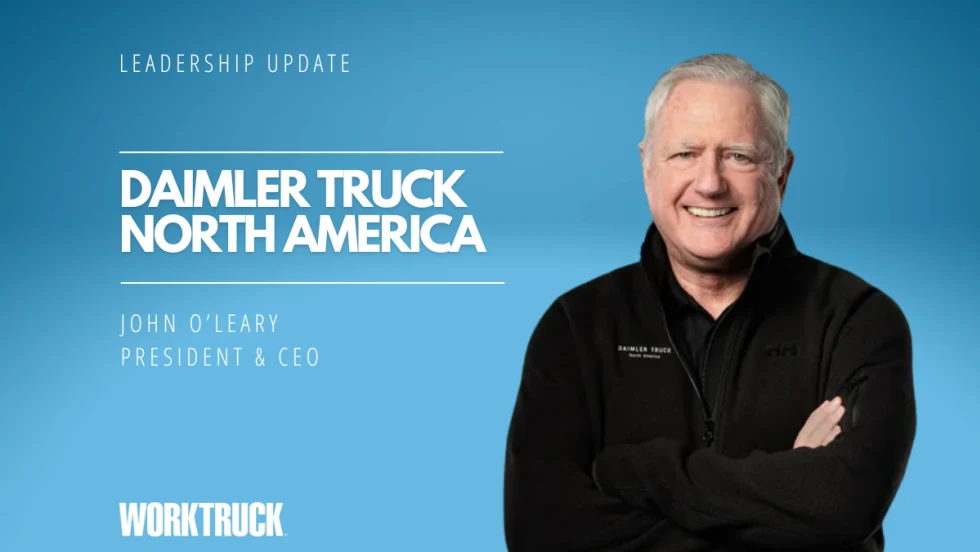 Graphic announcing a Daimler Truck North America leadership update featuring President and CEO John O’Leary smiling with arms crossed against a blue background, alongside Work Truck branding and title text.