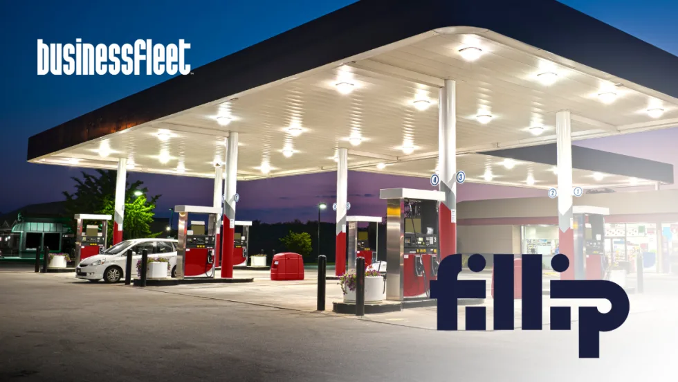 Gas station canopy and fuel pumps at dusk with a passenger vehicle parked near the pumps, illustrating fuel management solutions for small business fleets.