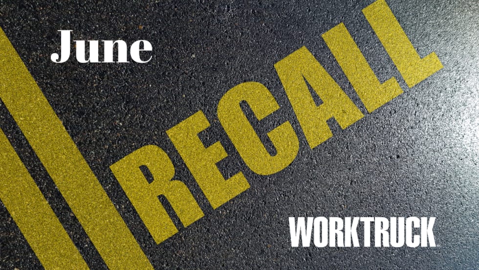 Graphic showing the word “RECALL” painted in large yellow letters across a road surface with double yellow center lines. “June” appears at top left, and the Work Truck logo appears at bottom right.