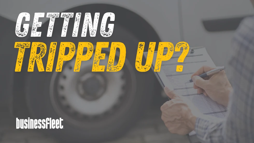 A commercial vehicle wheel and an inspector holding a clipboard appear behind the headline "Getting Tripped Up?" highlighting fleet compliance and roadside inspection challenges.