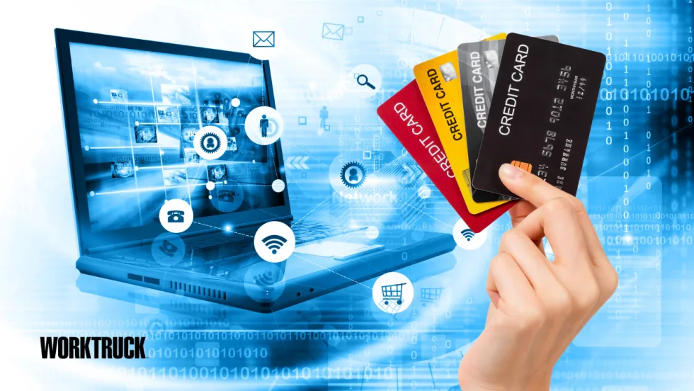 Illustration of a hand holding multiple business credit cards beside a laptop displaying connected digital commerce icons, representing fleet purchasing, electronic payments, invoicing, and B2B financial transactions.