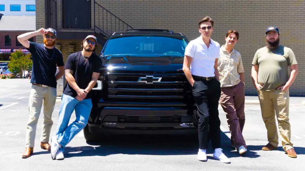 The Red Clay Strays pose with a Chevrolet Silverado, one of several vehicles featured in the revived "Heartbeat of America" campaign highlighting the brand's connection to hardworking Americans.