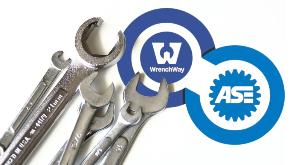 Several open-end wrenches are displayed beside the WrenchWay and ASE logos, illustrating a partnership focused on technician training, certification, and workforce development in the automotive and commercial vehicle repair industry.