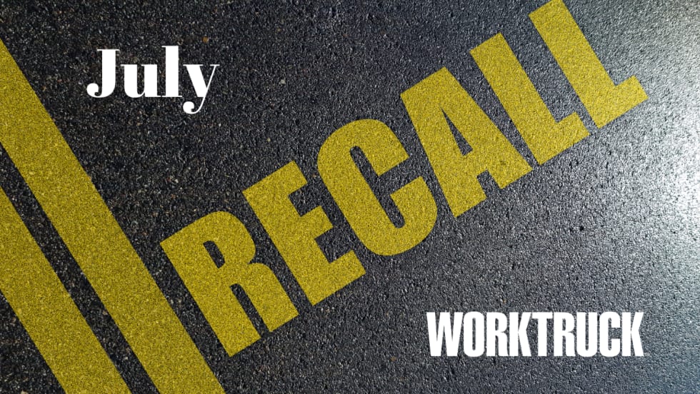Pavement background with double yellow lines and large text that says Recall, July, and Work Truck logo.