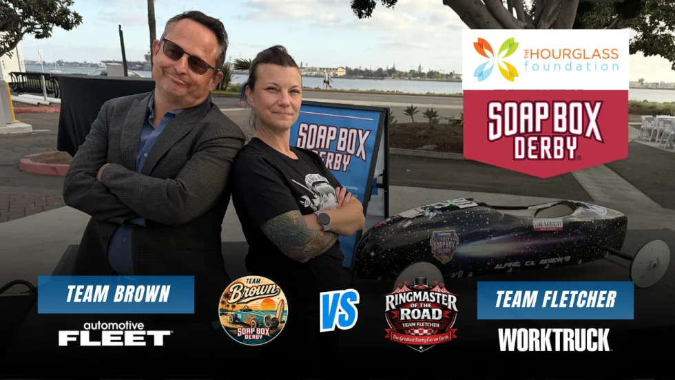 Chris Brown of Automotive Fleet and Lauren Fletcher of Work Truck pose beside a Soap Box Derby car in a Team Brown vs. Team Fletcher race graphic benefiting The Hourglass Foundation.