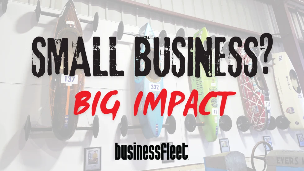 Vintage and modern Soap Box Derby cars displayed on a wall behind the words “Small Business? Big Impact” and the Business Fleet logo.