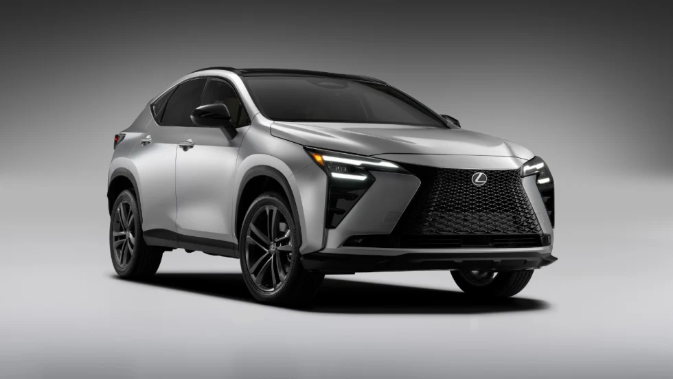 Silver 2027 Lexus NX compact crossover shown from the front three-quarter angle against a gray background.