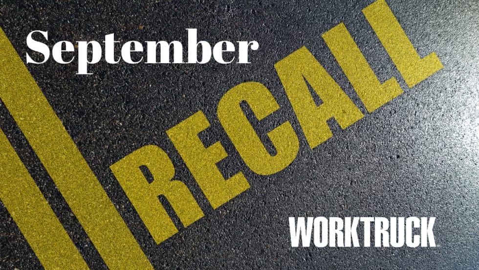Pavement background with double yellow lines and large text that says Recall, September, and Work Truck logo.
