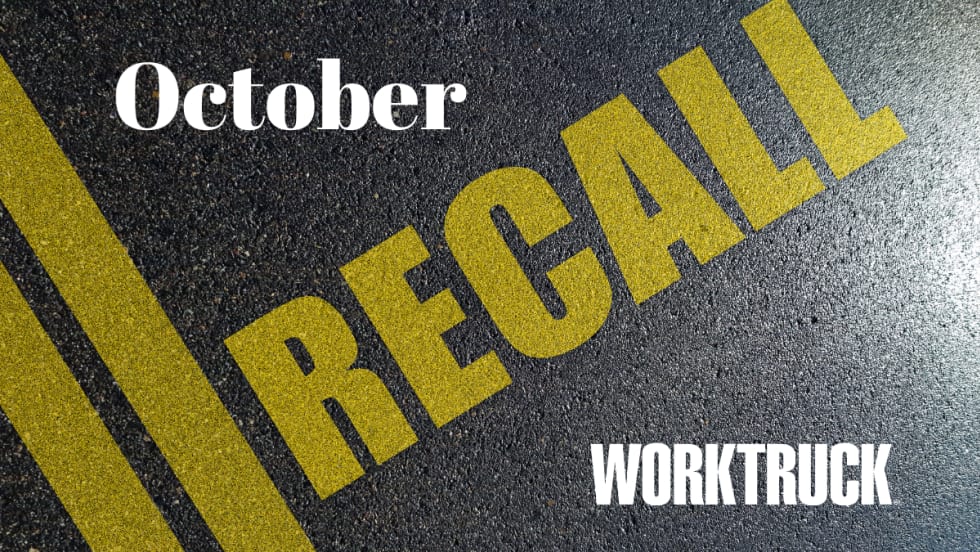 Pavement background with double yellow lines and large text that says Recall, October, and Work Truck logo.