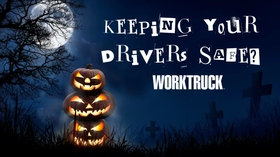 Three glowing jack-o’-lanterns beneath a full moon, with silhouetted trees and gravestones. Text reads “Keeping Your Drivers Safe?” above the Work Truck logo.