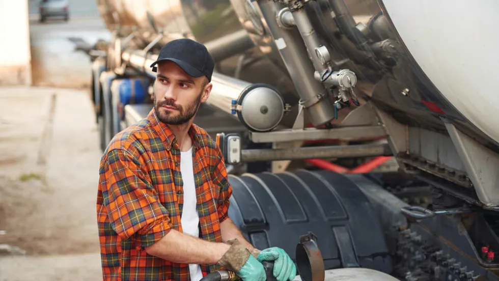 A person refueling his truck