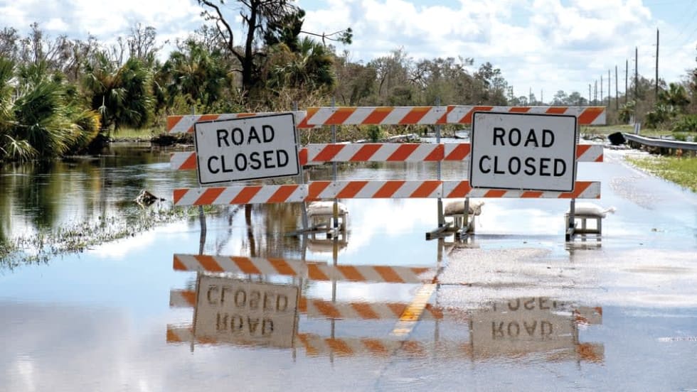 semi flooded road with sign Road closed