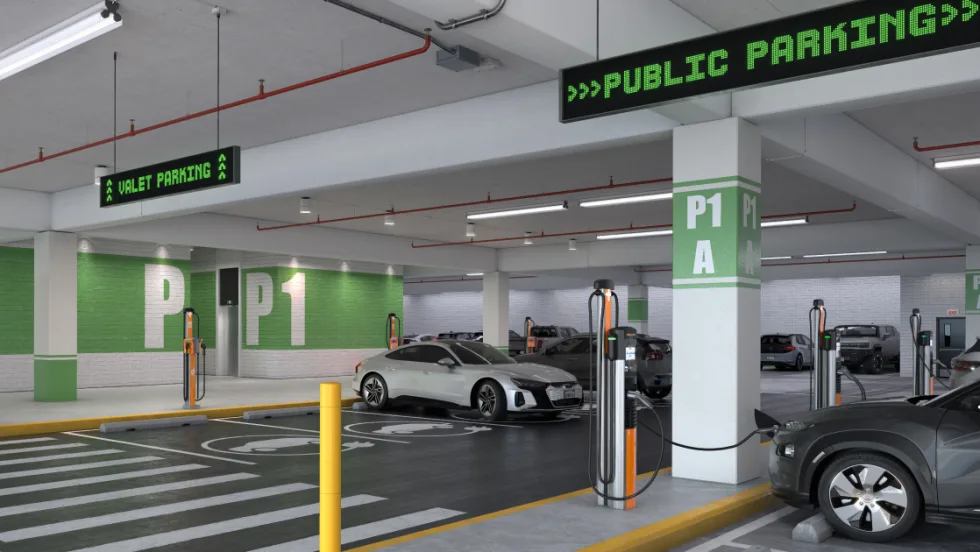 EVs charging along a row of fast chargers in an underground parking deck.
