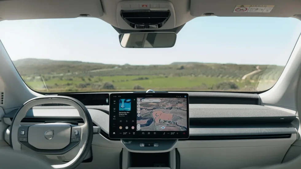Interior dashboard view of a Volvo EV featuring Google Maps navigation and infotainment display during a demo of upcoming Gemini AI vehicle integration.