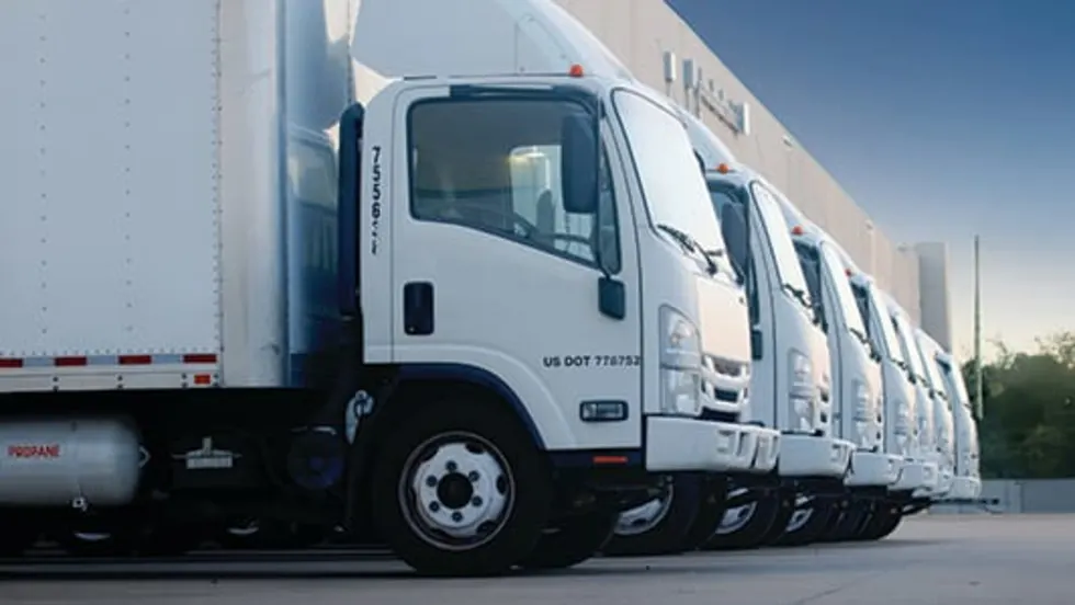 A line-up of white medium-duty trucks