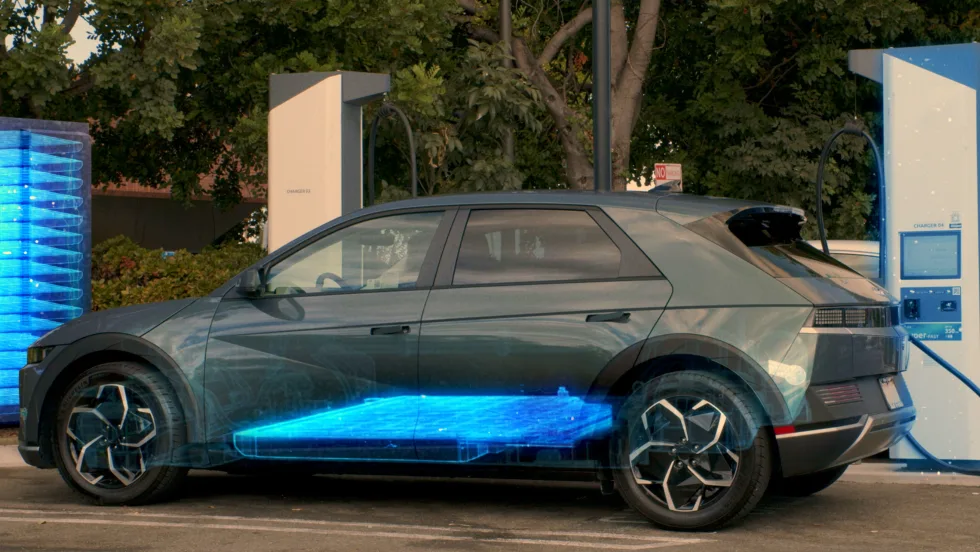 A grey Qnovo SUV's side profile with a blue hue signifying the latest charging feature.
