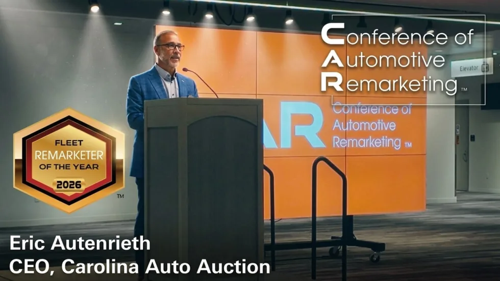 Eric Autenrieth accepts the Fleet Remarketer of the Year award on a stage at the CAR Conference in Cleveland, OH.
