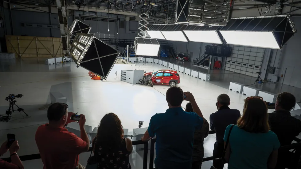 Attendees watch a live vehicle crash test at the IIHS Vehicle Research Center, where fleet professionals can observe safety testing and advanced crash-avoidance technologies in action.