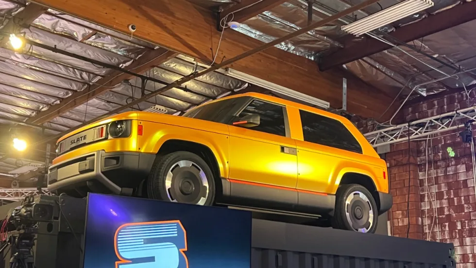 Yellow Slate Fastback on a raised platform in a warehouse.