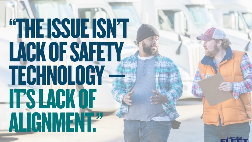 Two trucking industry workers talk in front of semi-trucks beside text reading, “The issue isn’t lack of safety technology — it’s lack of alignment.”