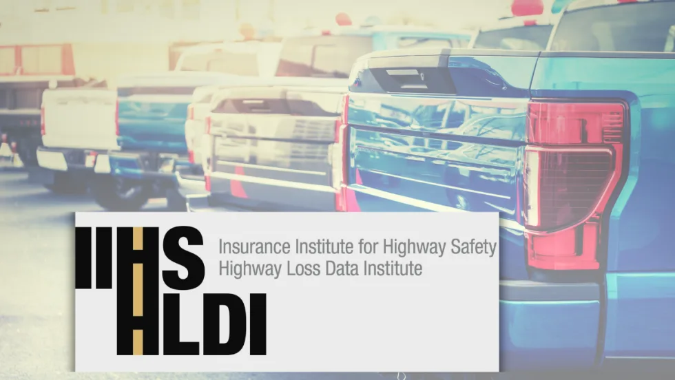 IIHS HLDI text overlaid on the trunks of pick up trucks.
