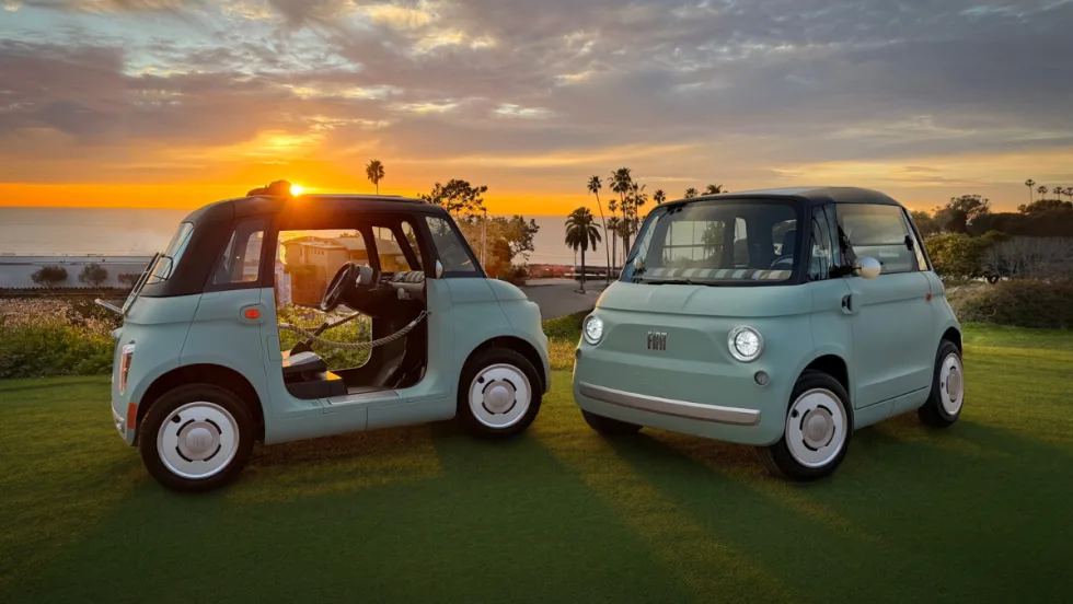 Two Fiat Topolino models shown on a bluff. 