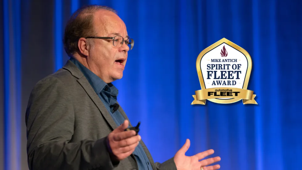 Mike Antich speaking, with Spirit of Fleet Award logo