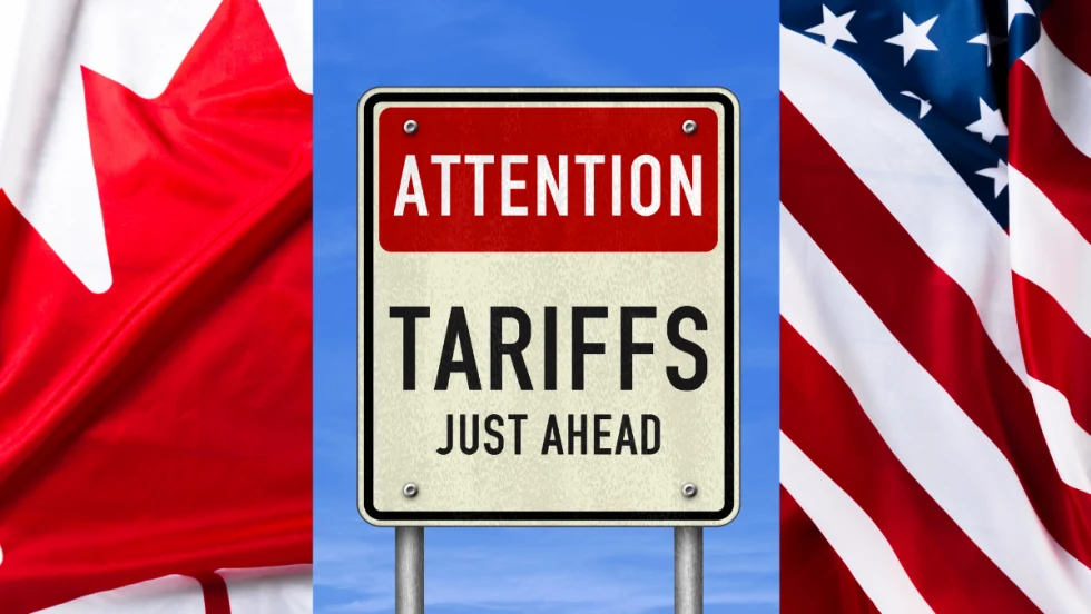 U.S. and Canadian flags and sign that says tariffs ahead