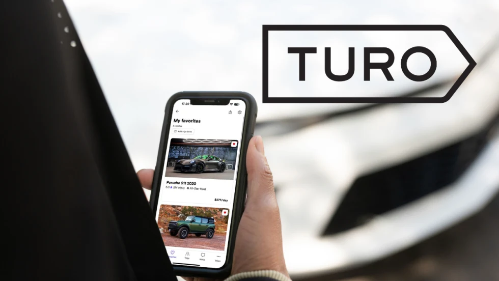 hand holding phone and Turo logo