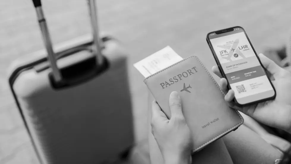 Photo of a suitcase, passport, and smartphone.
