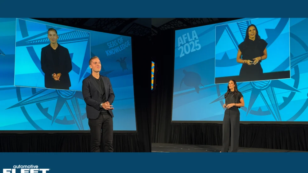 Two presenters stand before blue graphics featuring a compass and sea turtle design, highlighting fleet management innovation and leadership discussions at the annual AFLA event.