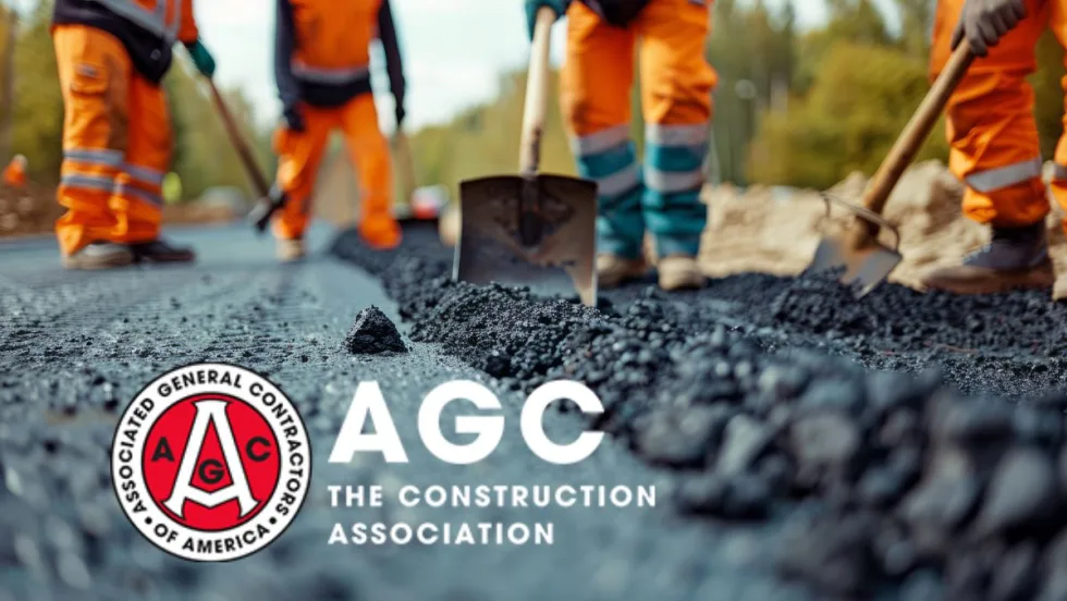 Construction workers are laying asphalt on the road.