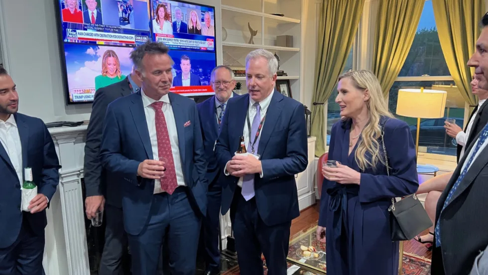 ACRA executives with a Congresswoman in the living room of an event house during a PAC fundraiser.